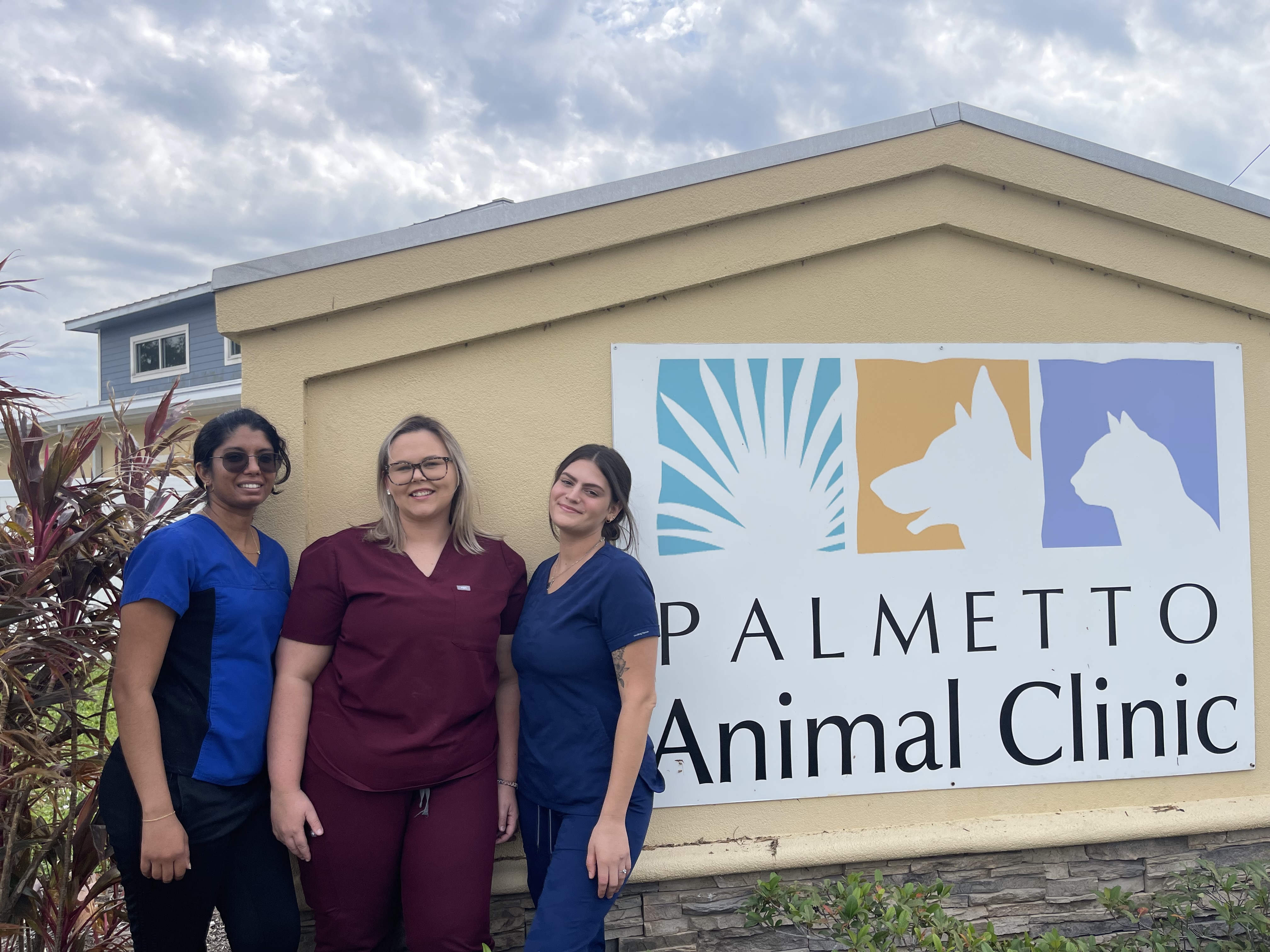 Staff Standing Next to Hospital Sign